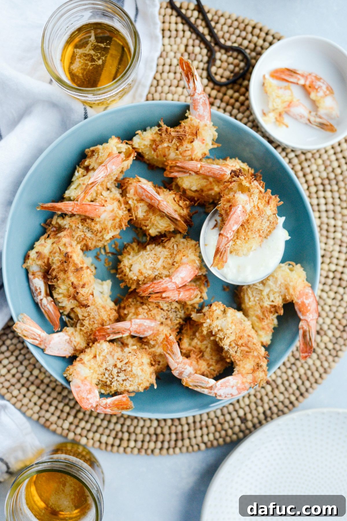 Tropical Crispy Air-Fried Coconut Shrimp with Pineapple Coconut Yogurt Dip 2 Air-Fryer Coconut Shrimp with Pineapple Coconut Yogurt Dip in a shallow blue bowl
