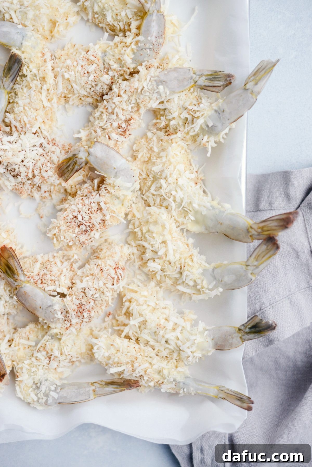 Tropical Crispy Air-Fried Coconut Shrimp with Pineapple Coconut Yogurt Dip 14 coated shrimp on parchment lined sheet pan