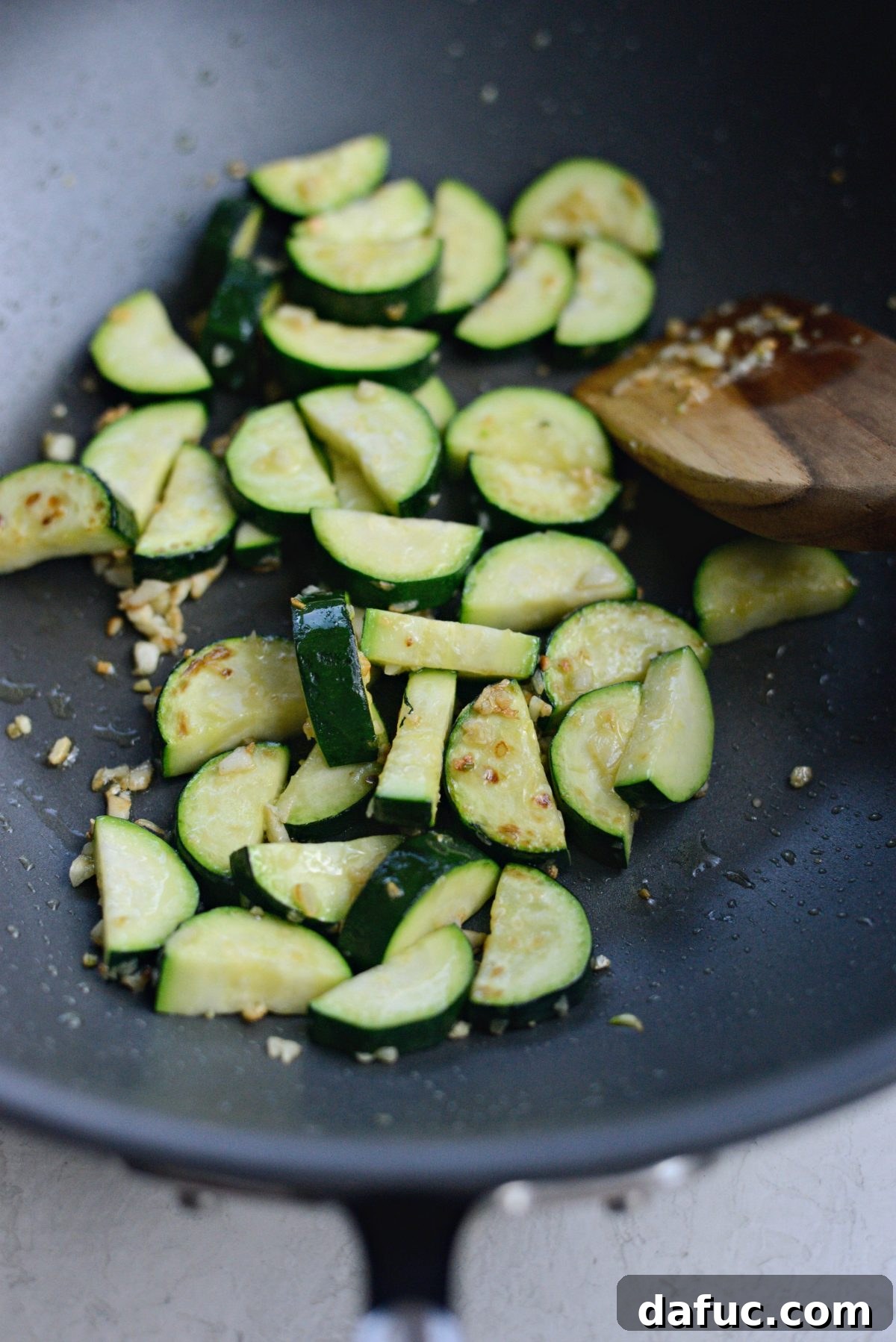 Sautéed zucchini and garlic in a wok