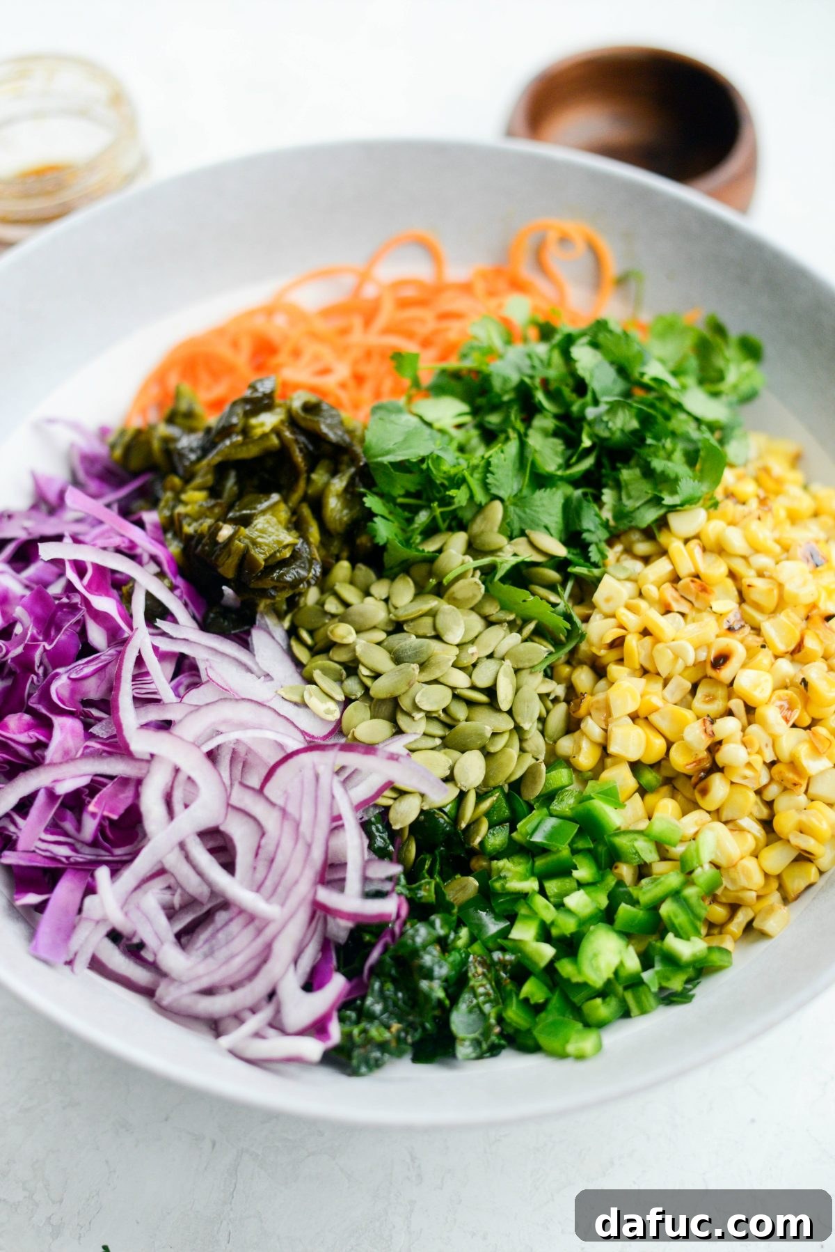 Southwest Sweet Potato Noodle Fiesta with Poblano Corn 13 Lacinato kale being massaged with dressing and salt for a tender texture