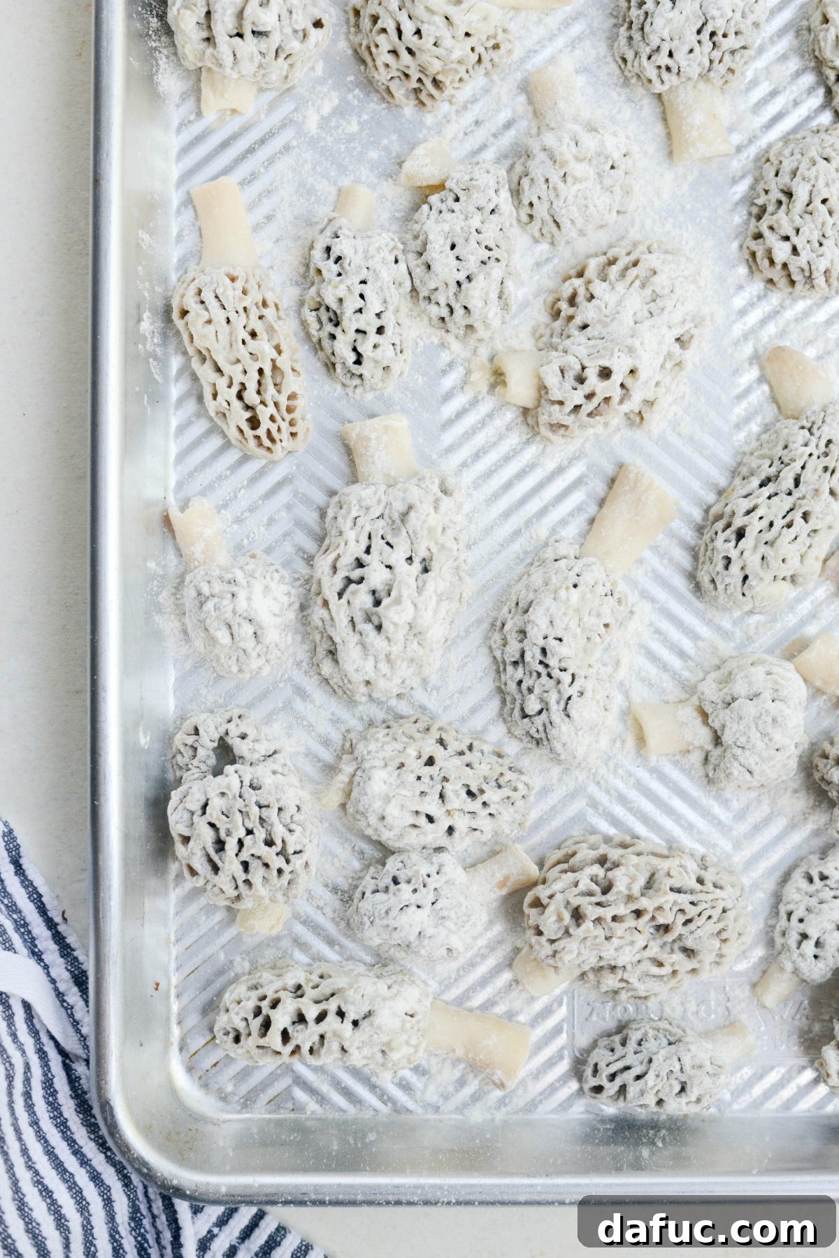 Spring's Wild Morel Sauté 15 Floured morel mushrooms on a baking sheet