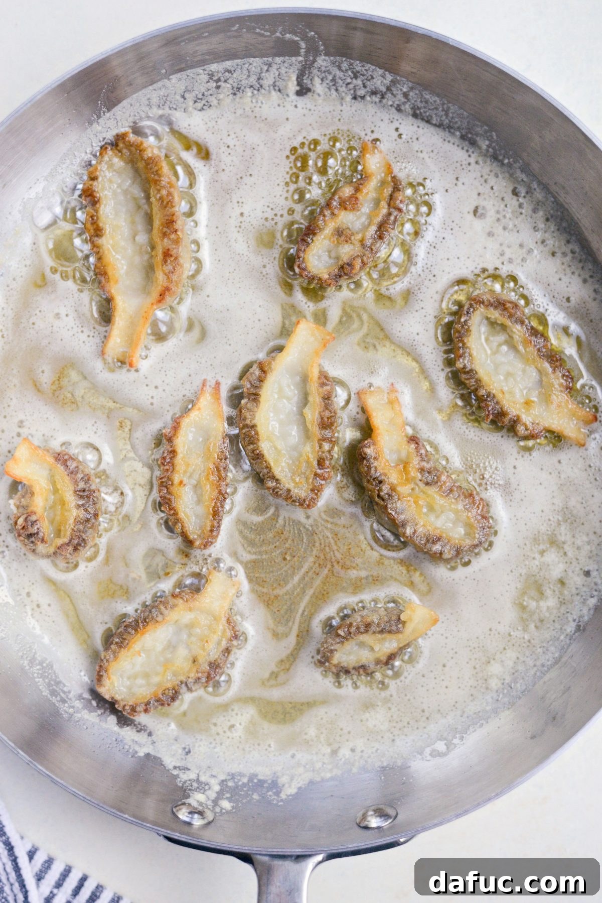 Spring's Wild Morel Sauté 18 Golden brown pan-fried morel mushrooms in a skillet