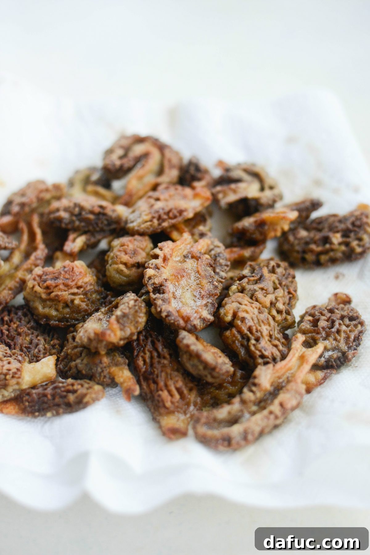 Spring's Wild Morel Sauté 19 Cooked morel mushrooms being removed from the pan