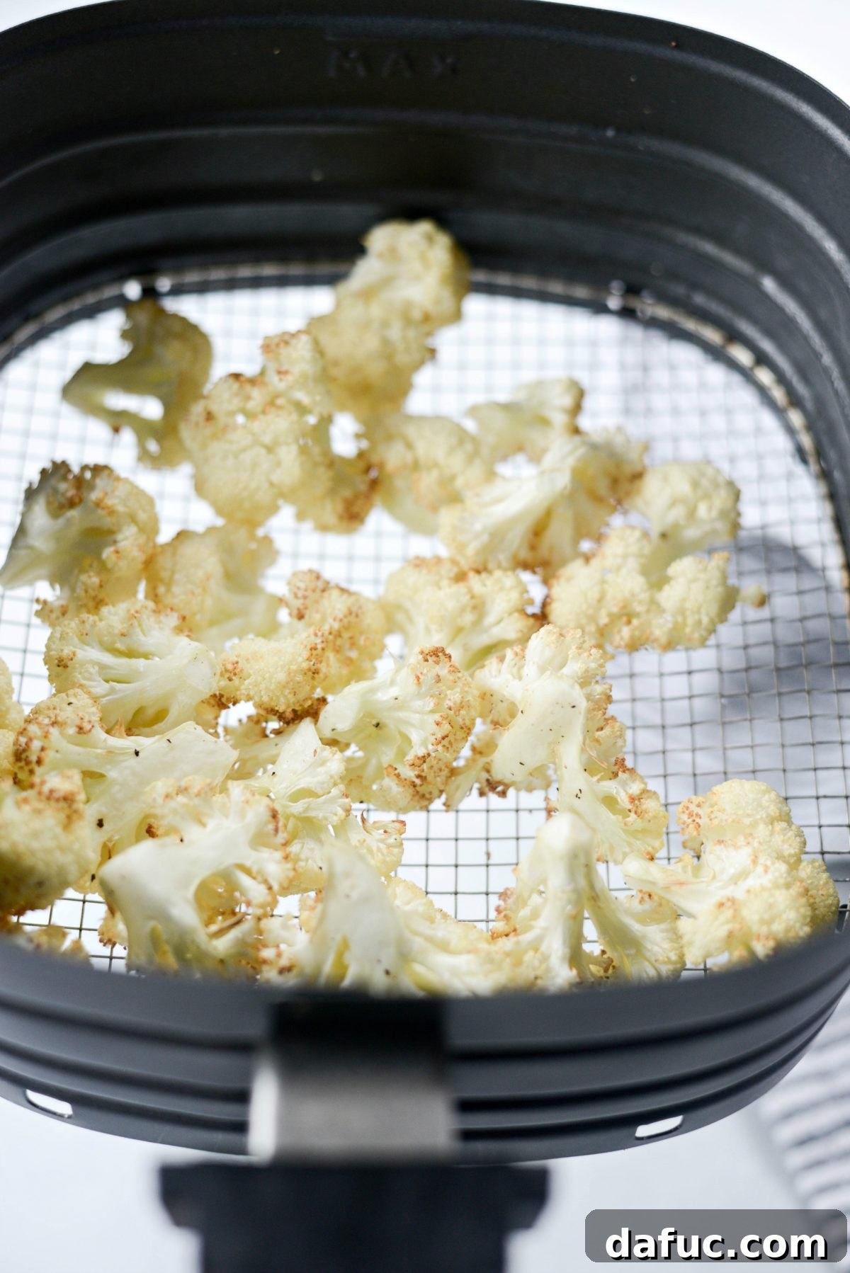 Second batch of cauliflower florets being air fried