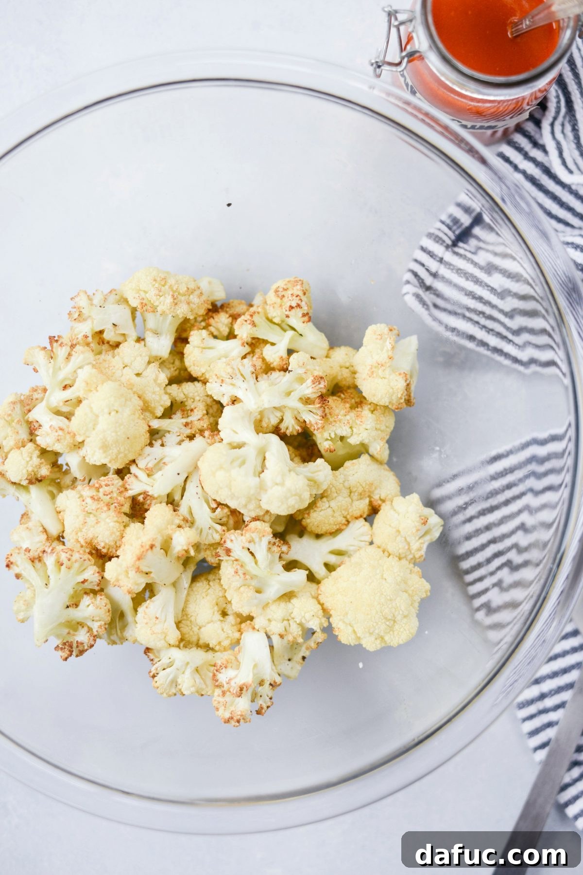Golden brown air-fried cauliflower bites in a bowl