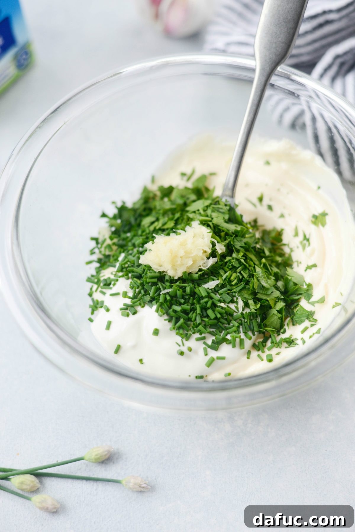 Mixing Garlic Blue Cheese Dip ingredients in a bowl