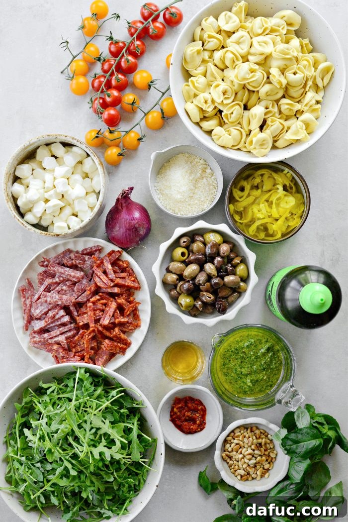 Italian Tortellini Pasta Salad ingredients laid out on a table