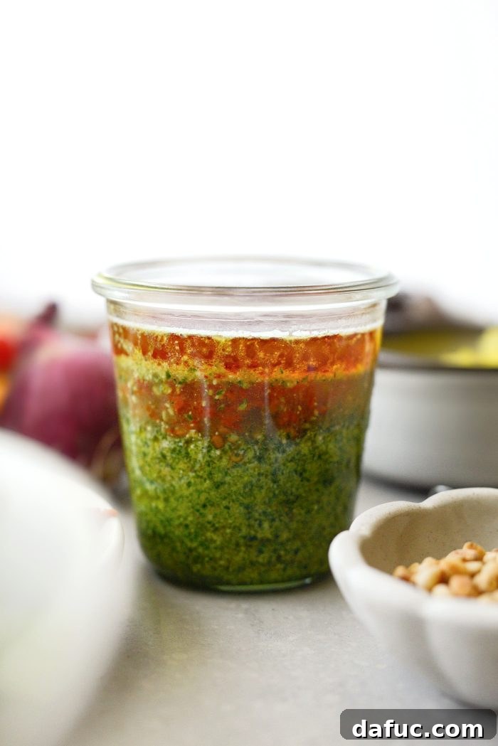 Pesto vinaigrette ingredients in a jar, ready to be shaken or stirred