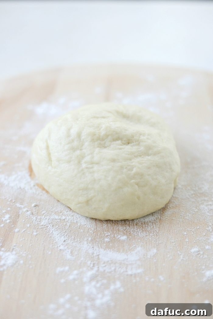 Mastering Homemade Pizza Dough 12 Risen pizza dough on a floured surface