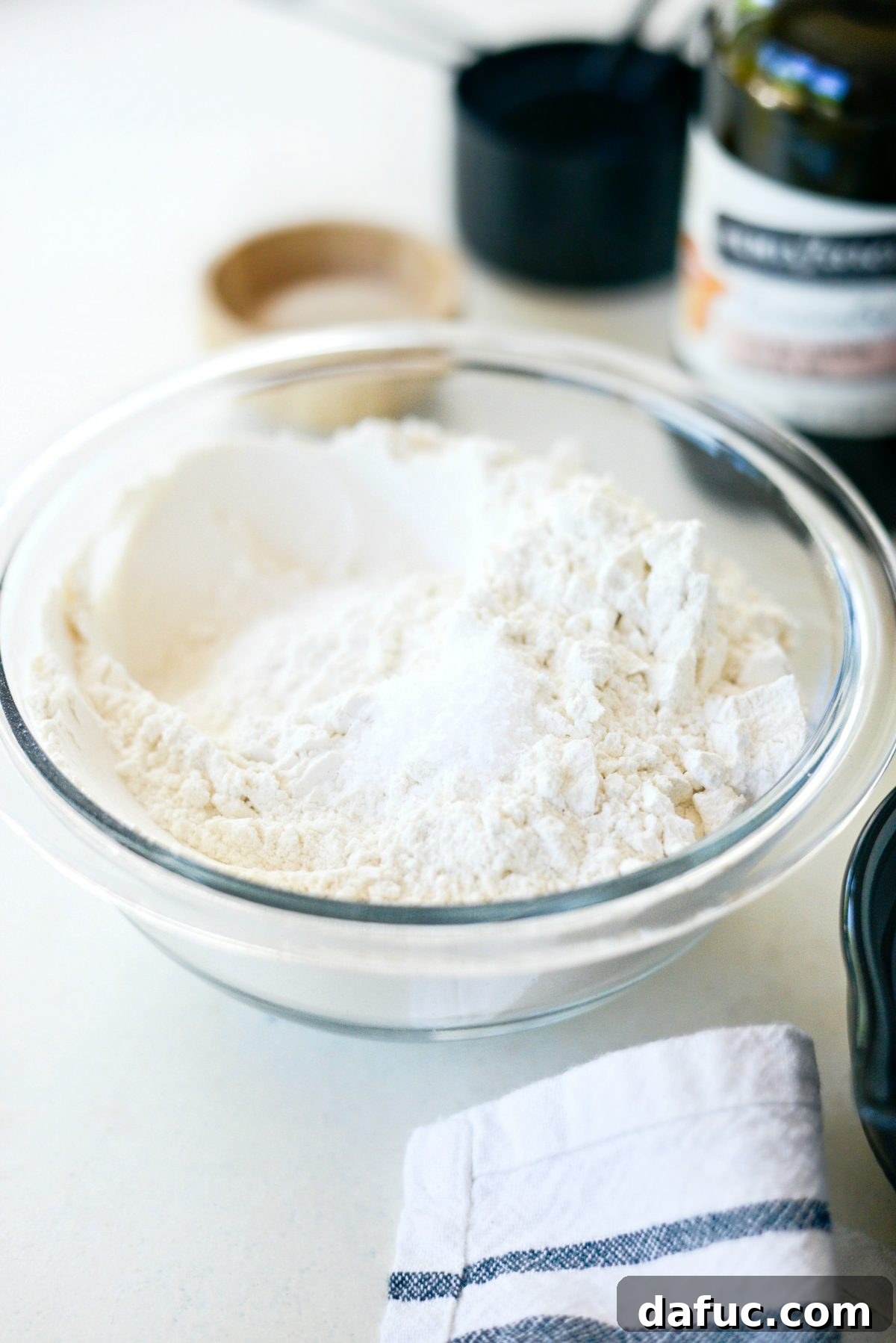 Mastering Homemade Pizza Dough 4 Flour and kosher salt mixed in a bowl for pizza dough