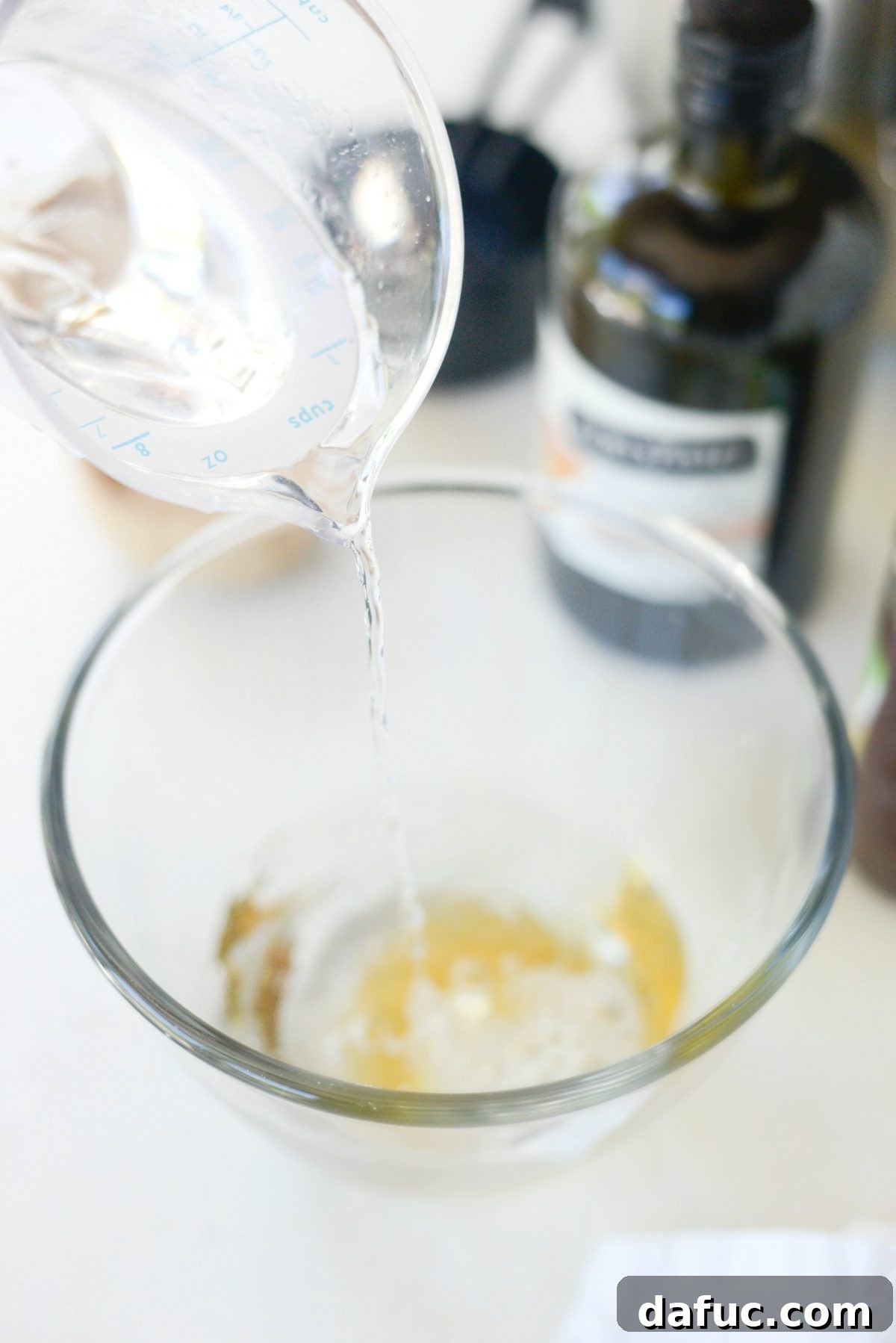 Mastering Homemade Pizza Dough 5 Honey dissolving in warm water for yeast activation