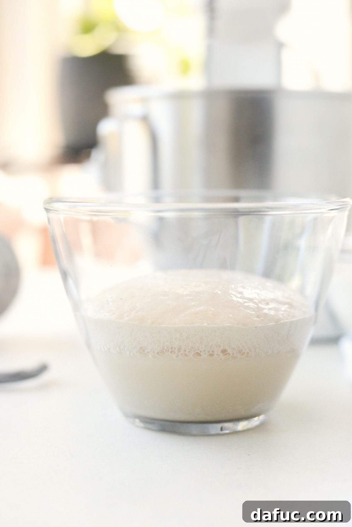 Mastering Homemade Pizza Dough 7 Yeast mixture in a clear bowl before adding to stand mixer