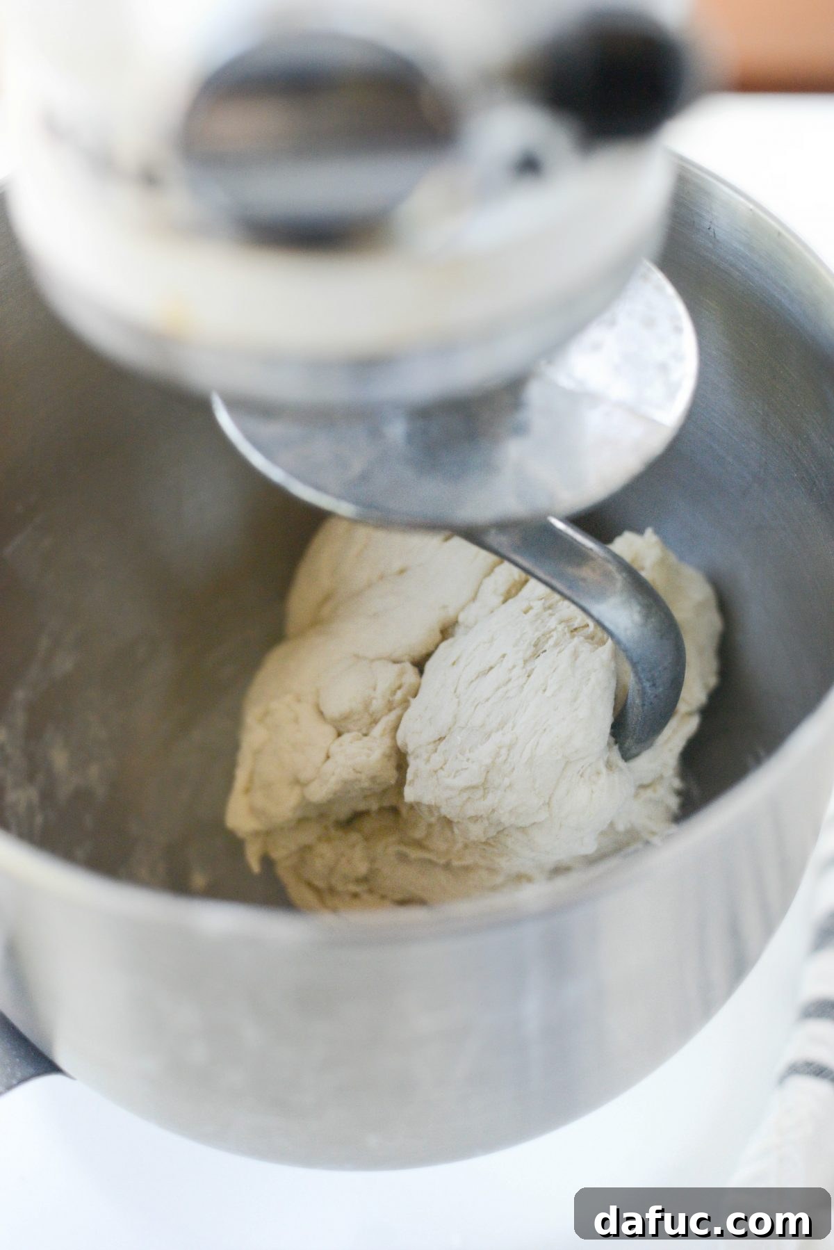 Mastering Homemade Pizza Dough 10 Pizza dough being kneaded with a dough hook in a stand mixer