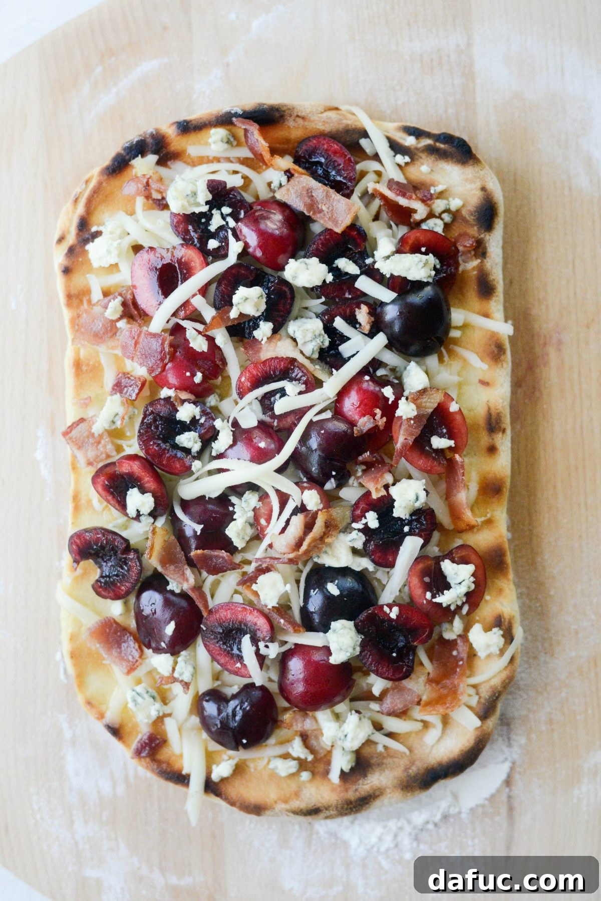 Adding fresh toppings to a partially grilled flatbread
