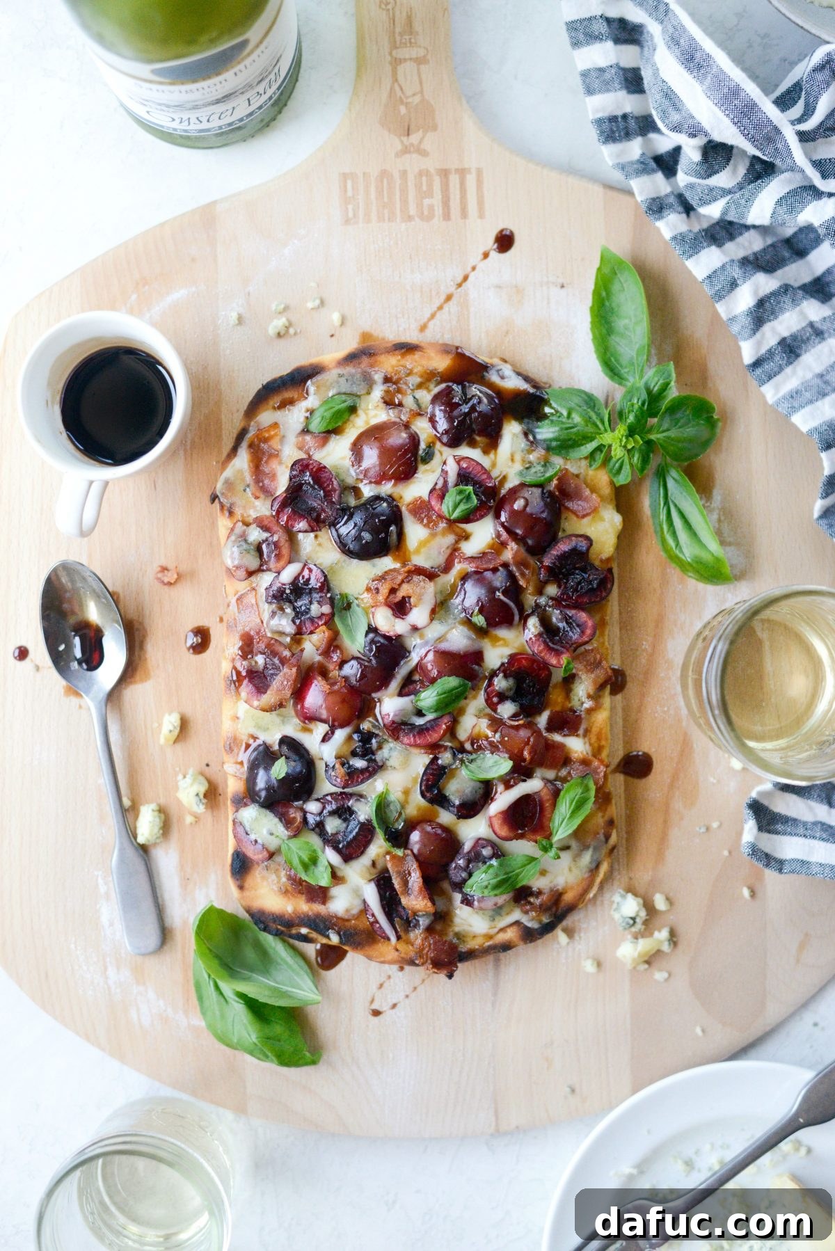 Artfully plated Grilled Cherry Gorgonzola Flatbread Pizza with basil
