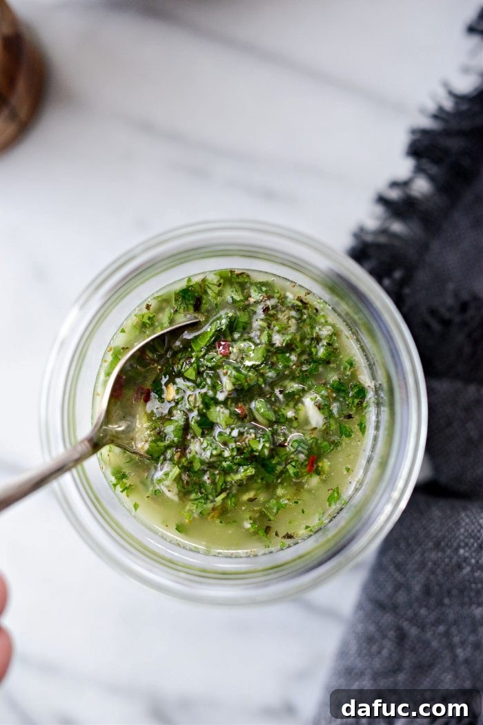 Garden Fresh Chimichurri 13 Finished Homemade Chimichurri in a jar with a spoon