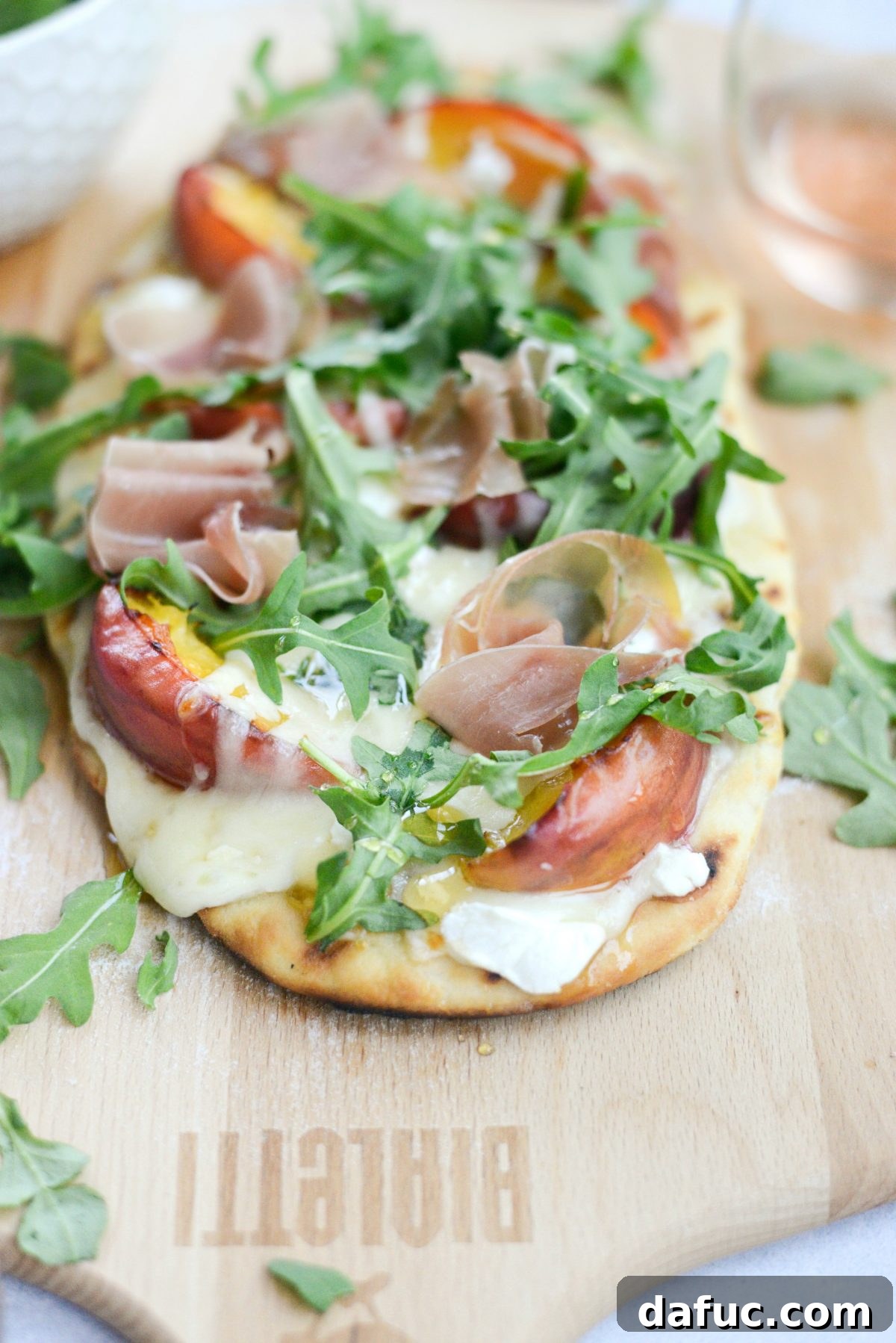 Another mouth-watering shot of the Grilled Peach, Goat Cheese and Prosciutto Flatbread, ready to be served