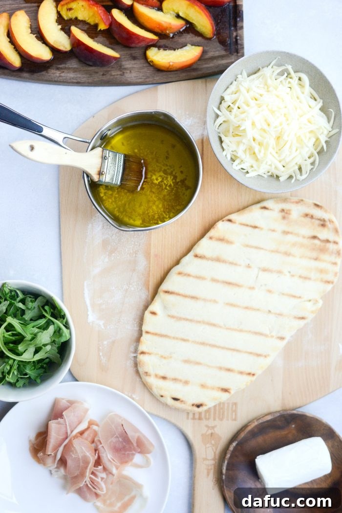 Ingredients for Grilled Peach, Goat Cheese and Prosciutto Flatbread displayed on a cutting board