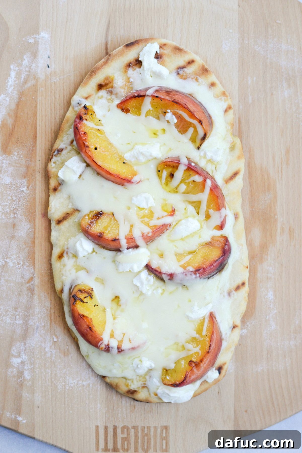 Flatbread on the grill, cheese melting and crust cooking to perfection