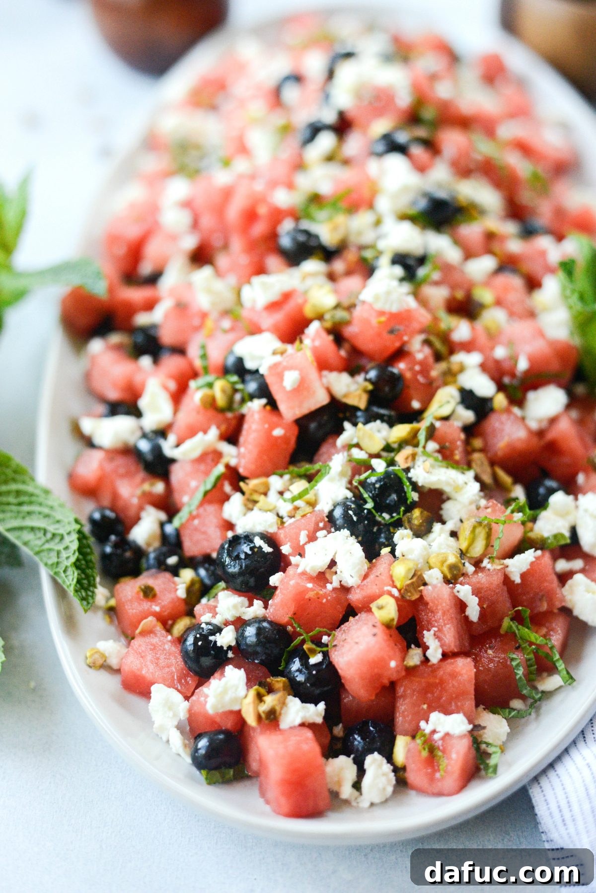 A bowl of Watermelon Blueberry Feta Salad featuring vibrant red watermelon, blue blueberries, and white feta cheese.
