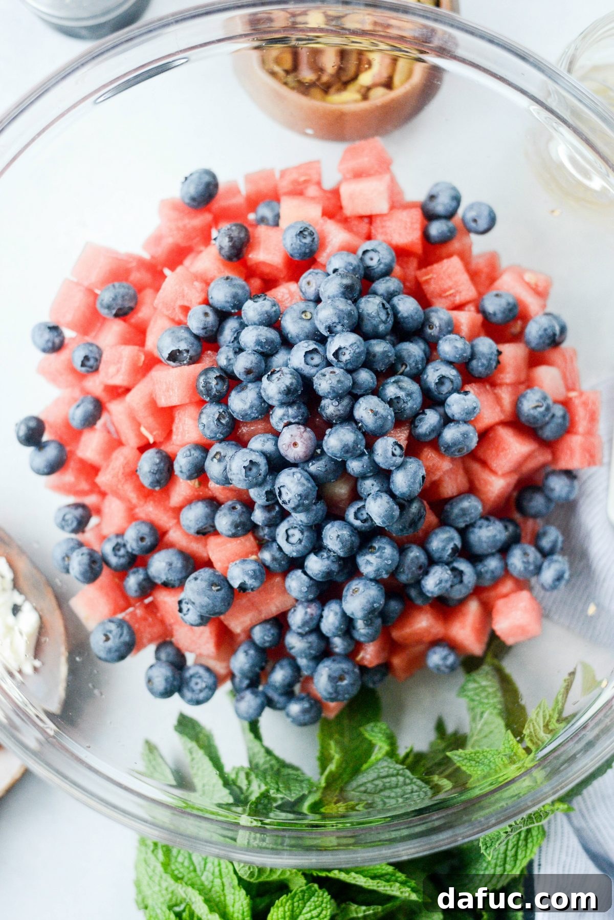 Watermelon and blueberries combined in a bowl, showing the red and blue colors.