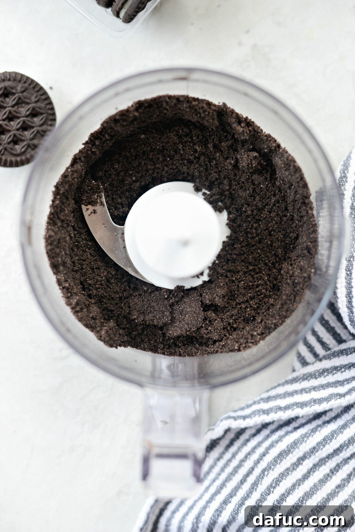 Grinding chocolate sandwich cookies into fine crumbs in a food processor
