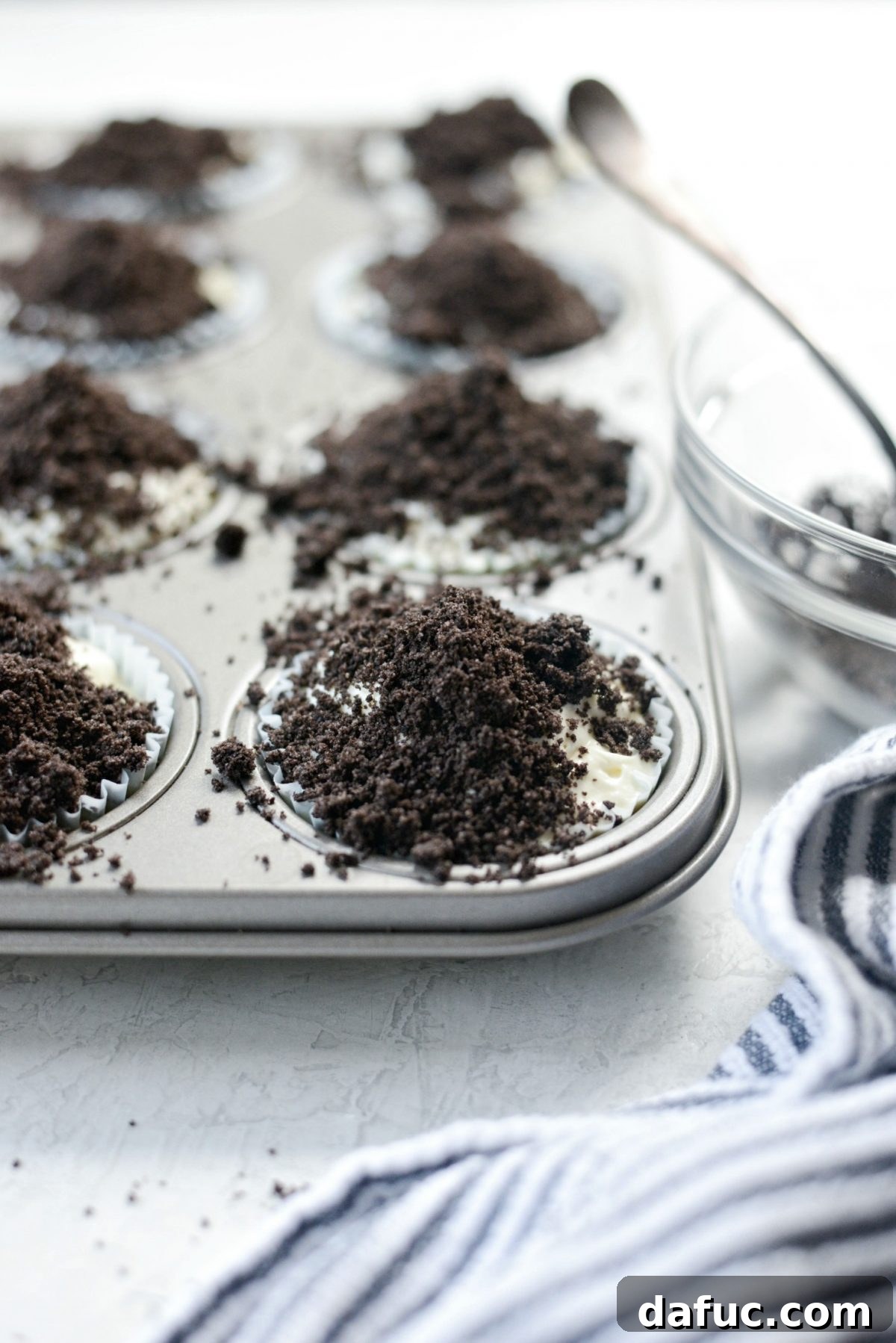 Decadent No-Bake Cookies and Cream Cheesecake Bites 17 Sprinkling delicate cookie crumbs evenly over the tops of the individual No-Bake Cookies and Cream Mini Cheesecakes