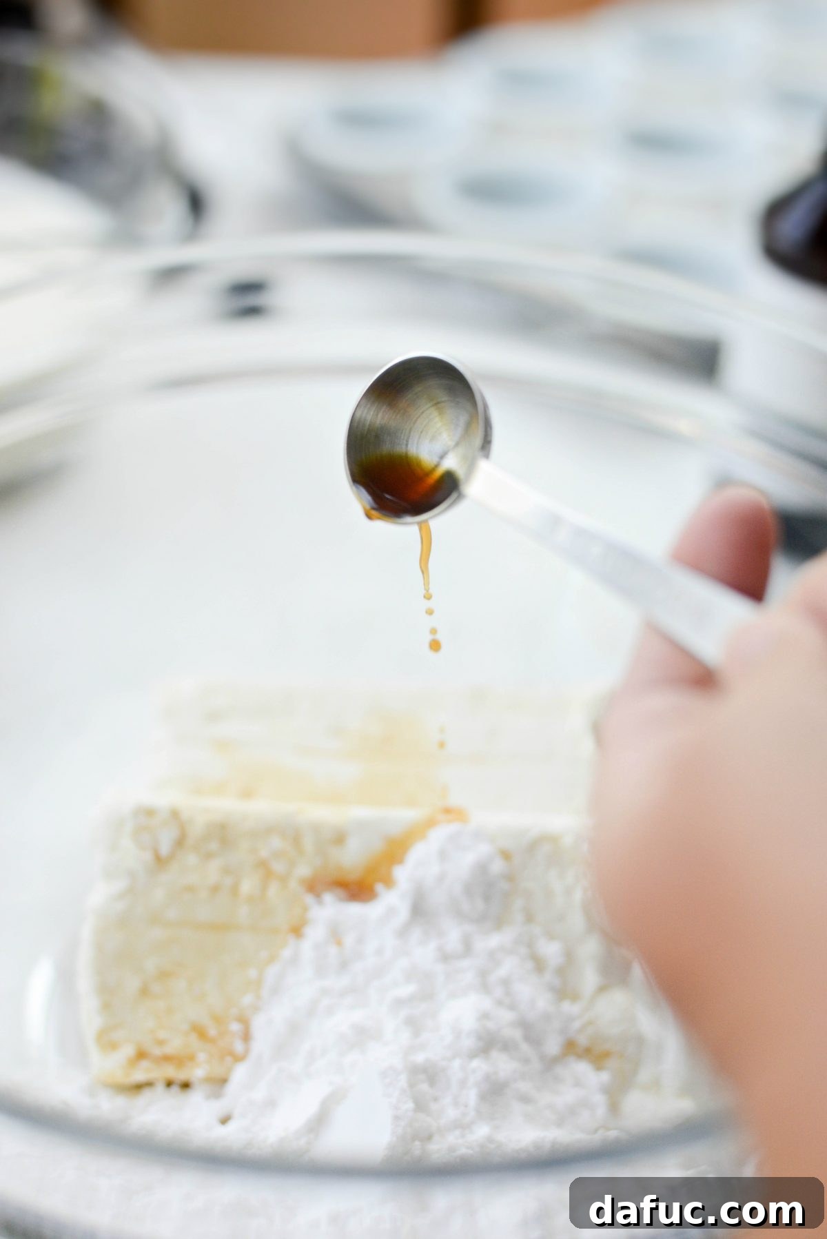 Adding pure vanilla extract to the cheesecake mixture