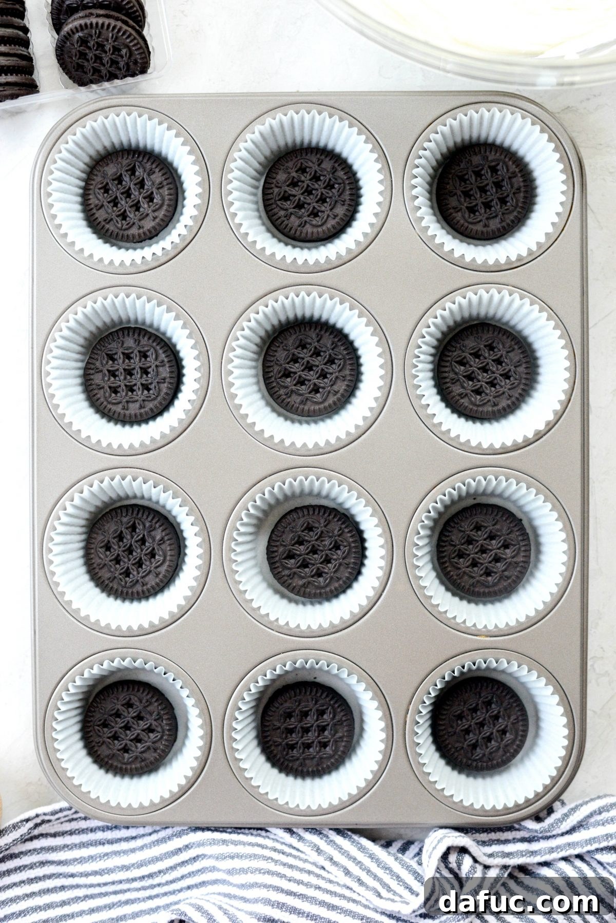 Decadent No-Bake Cookies and Cream Cheesecake Bites 10 Individual chocolate sandwich cookies carefully placed into the bottom of paper-lined muffin cups