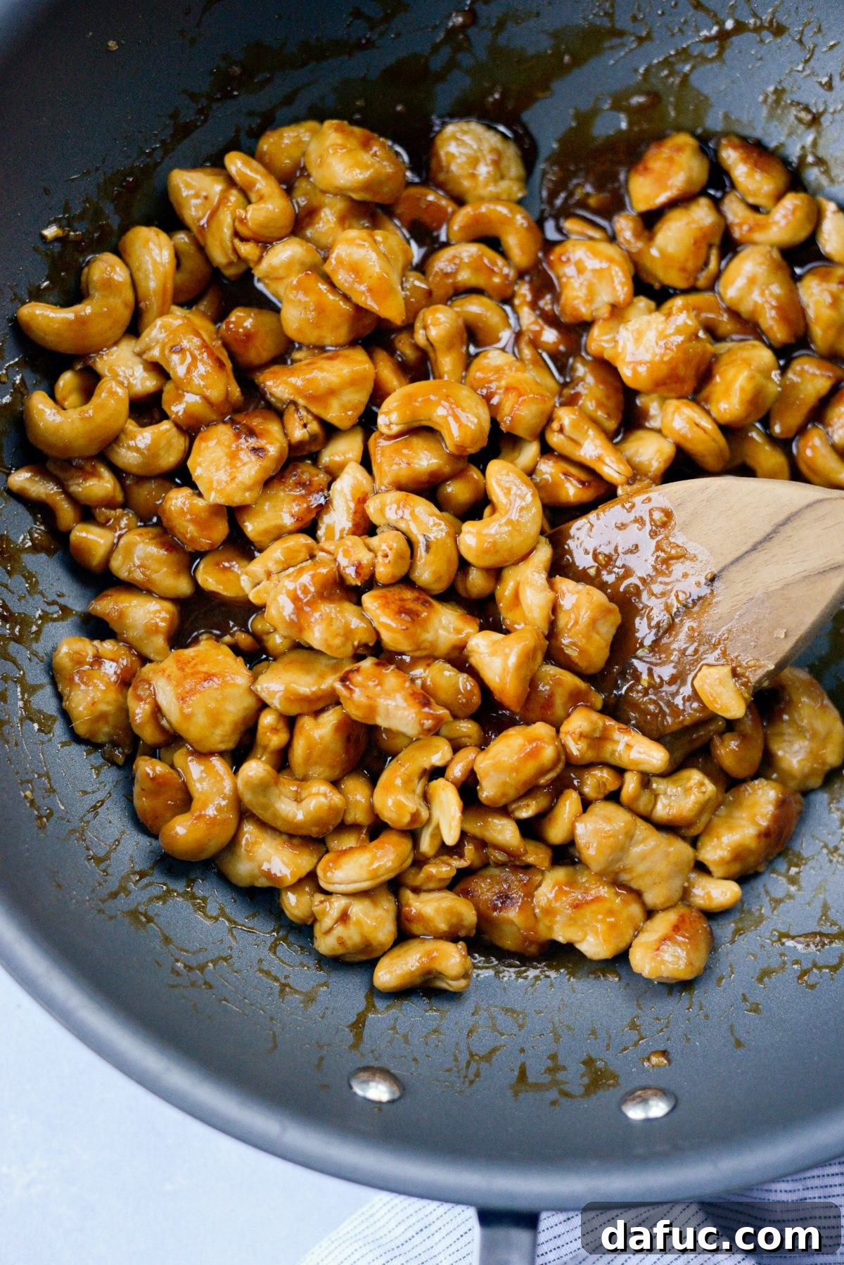 Toss chicken and cashews until heated through and sauce thickens.