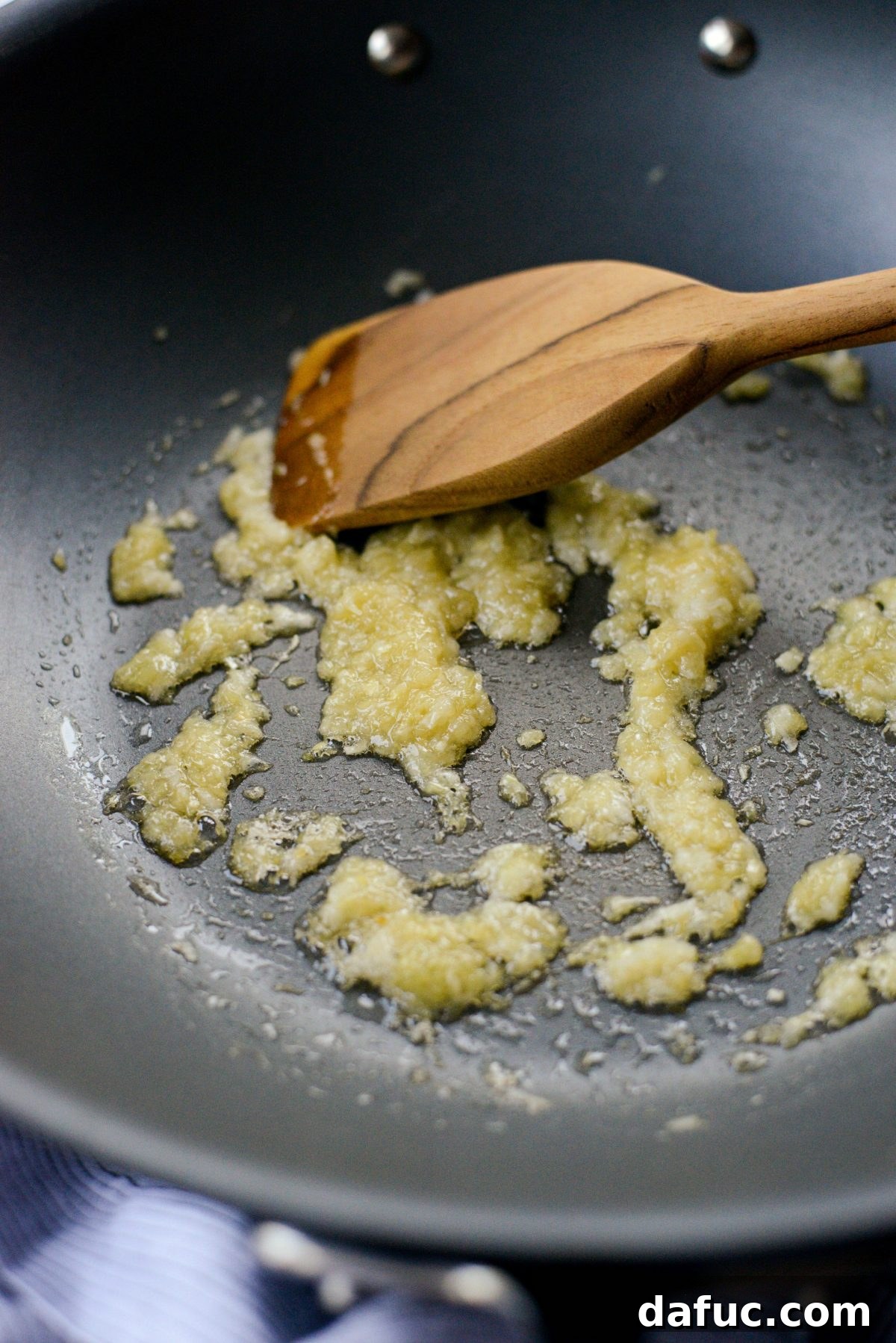 Sautéing lemongrass, ginger, and garlic in sesame oil.
