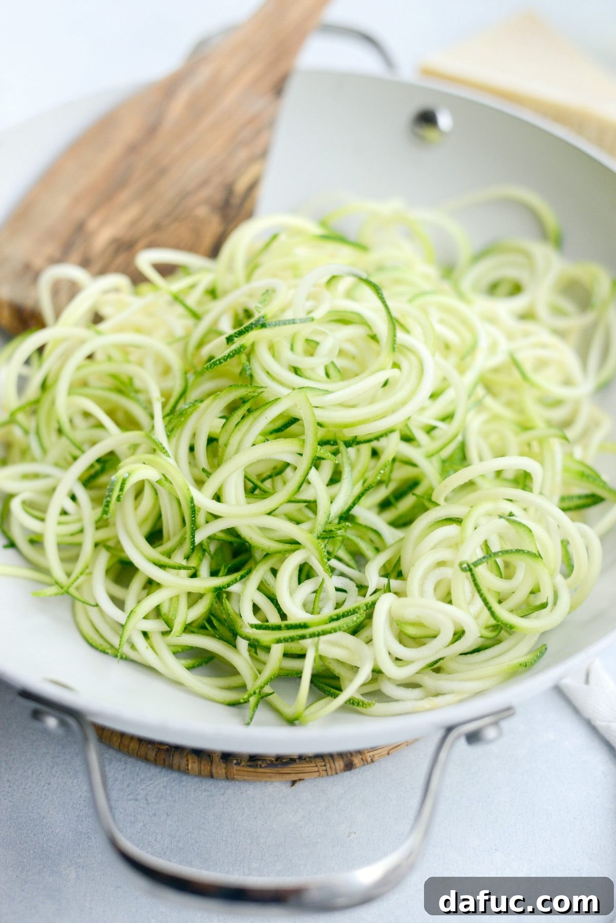 Quick and Flavorful Garlic Parmesan Zucchini Noodles 8 Adding zucchini noodles to the pan with garlic and oil