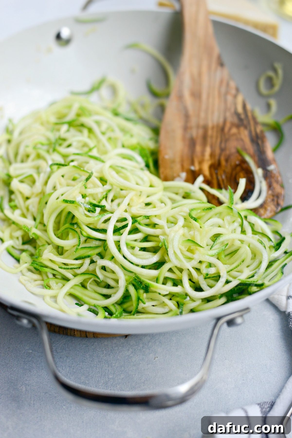 Quick and Flavorful Garlic Parmesan Zucchini Noodles 9 Stirring and cooking zucchini noodles in a skillet