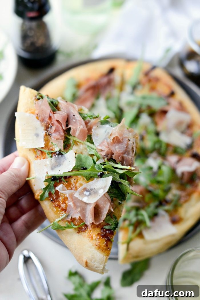 Whole Fig Jam Prosciutto Pizza on a cutting board, ready to serve
