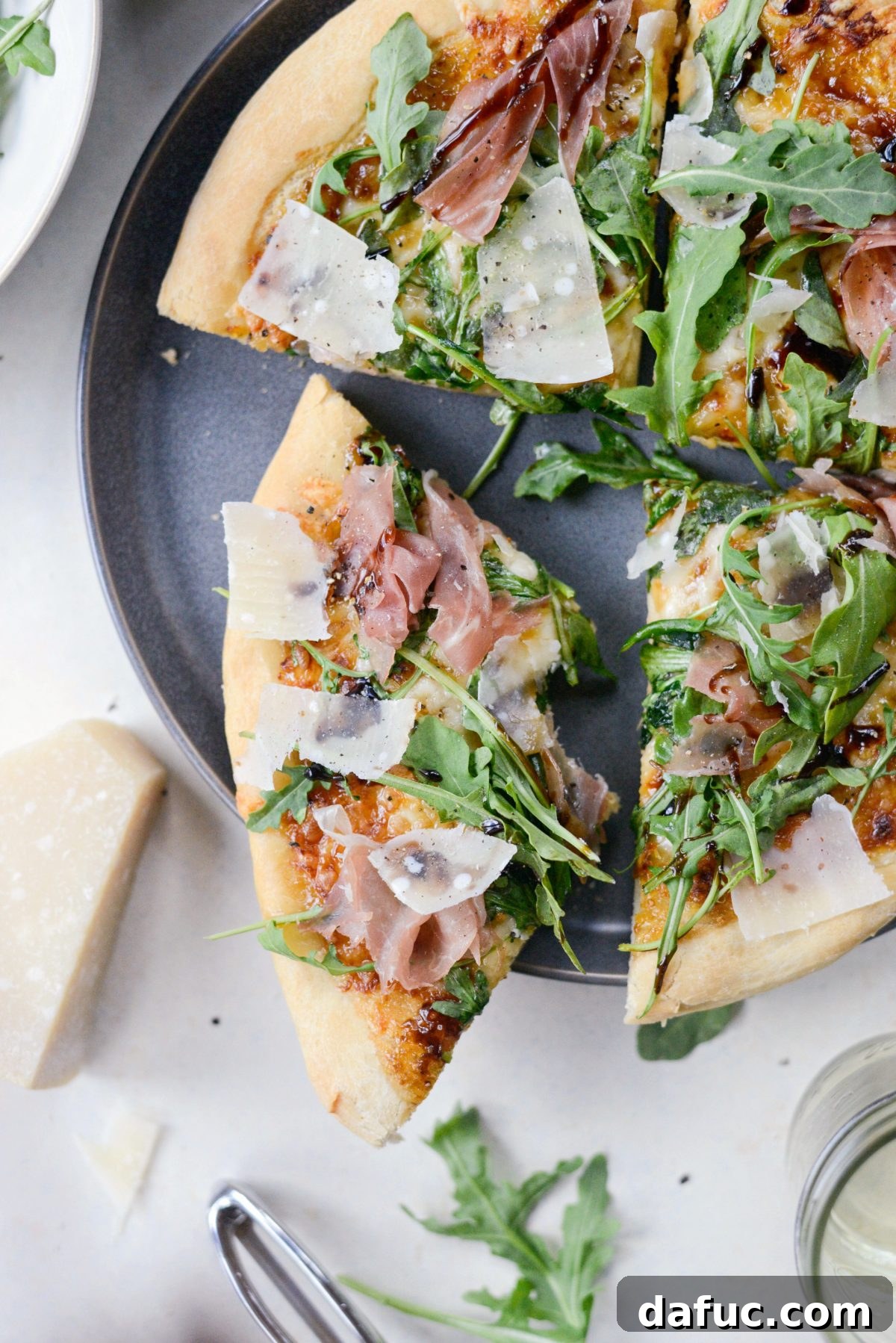 Delicious Fig Jam Prosciutto Pizza with fresh arugula and balsamic glaze
