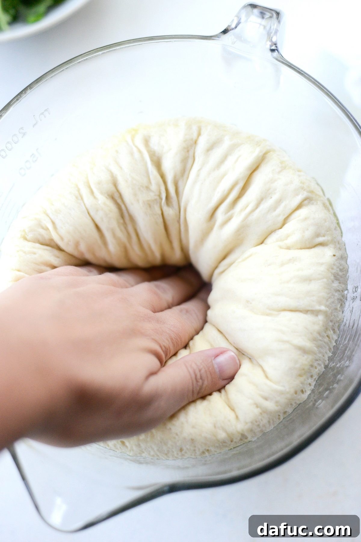 Deflating the homemade pizza dough