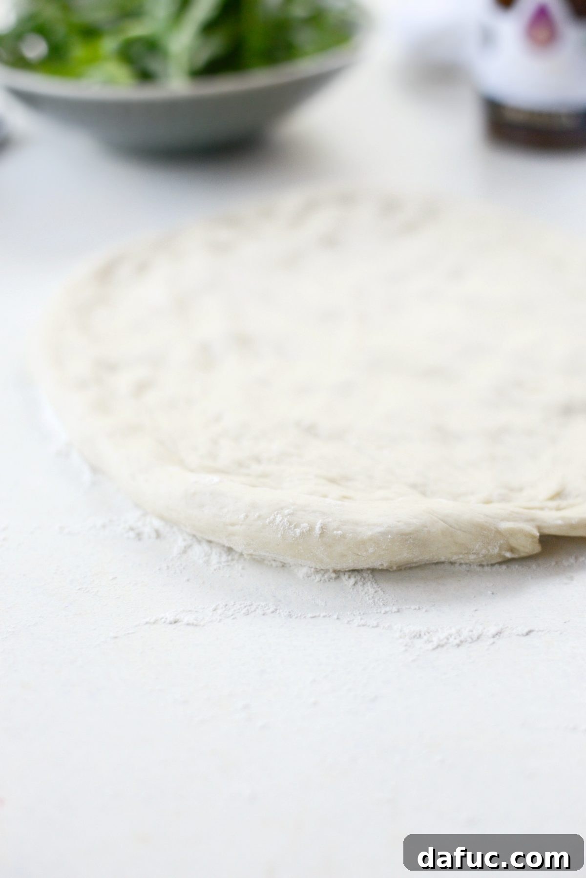 Stretching pizza dough into shape