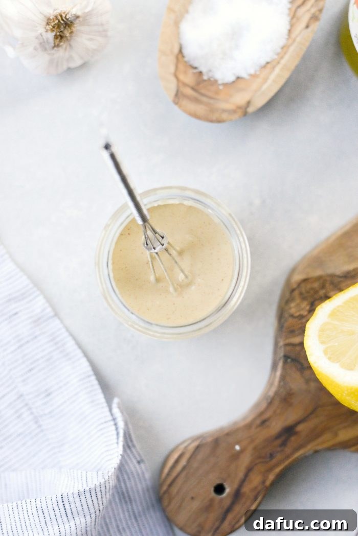 Zesty Lemon Tahini Dressing 3 Simple Lemon Tahini Dressing poured over roasted vegetables in a bowl