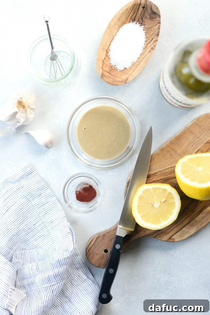 Zesty Lemon Tahini Dressing 4 Ingredients for Simple Lemon Tahini Dressing laid out on a kitchen counter