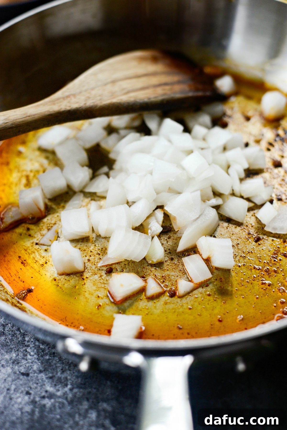 Hearty Chorizo and Sweet Potato Chilaquiles 6 Sautéing diced yellow onion in chorizo fat in a skillet