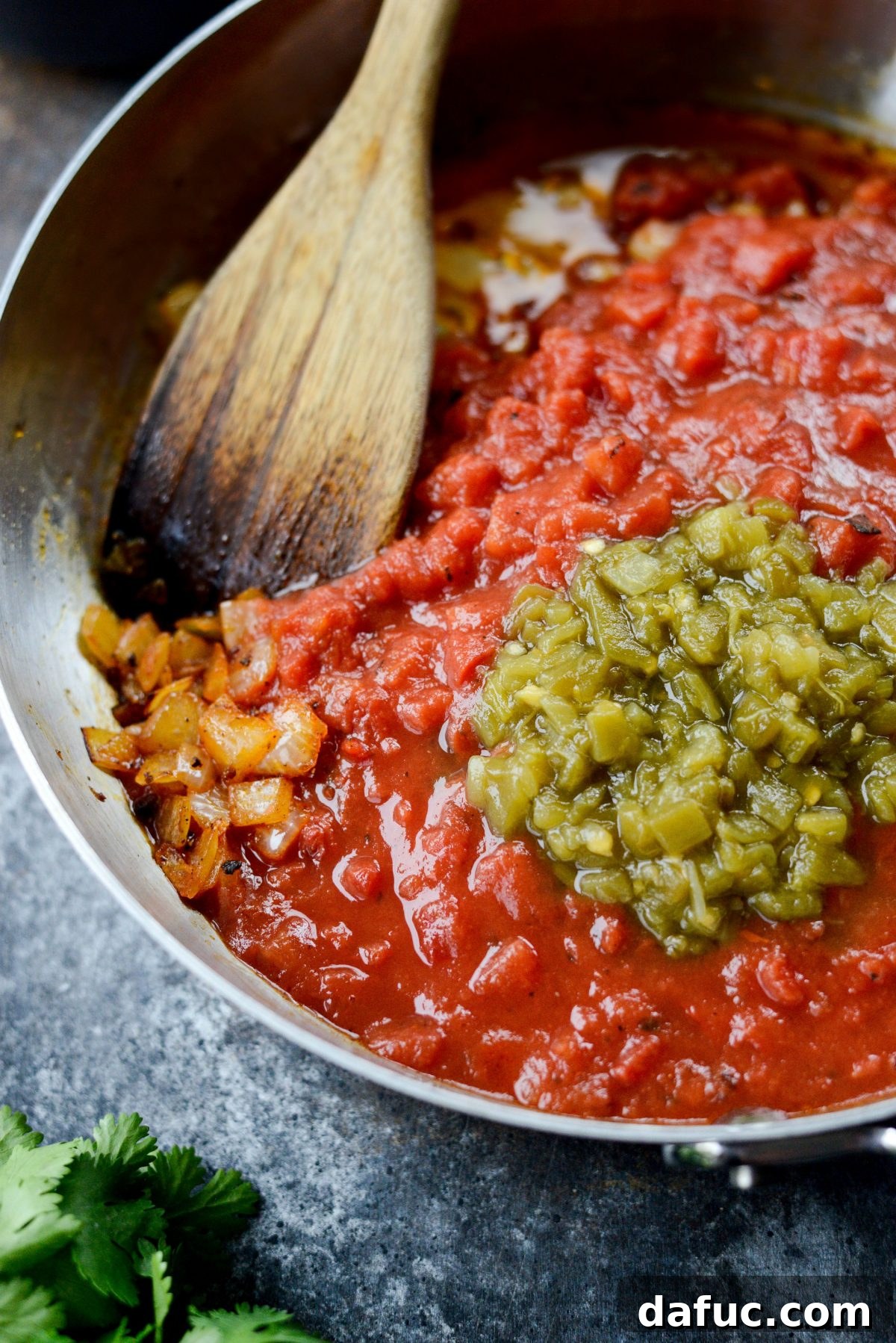 Hearty Chorizo and Sweet Potato Chilaquiles 8 Adding crushed fire-roasted tomatoes and diced green chiles to the skillet
