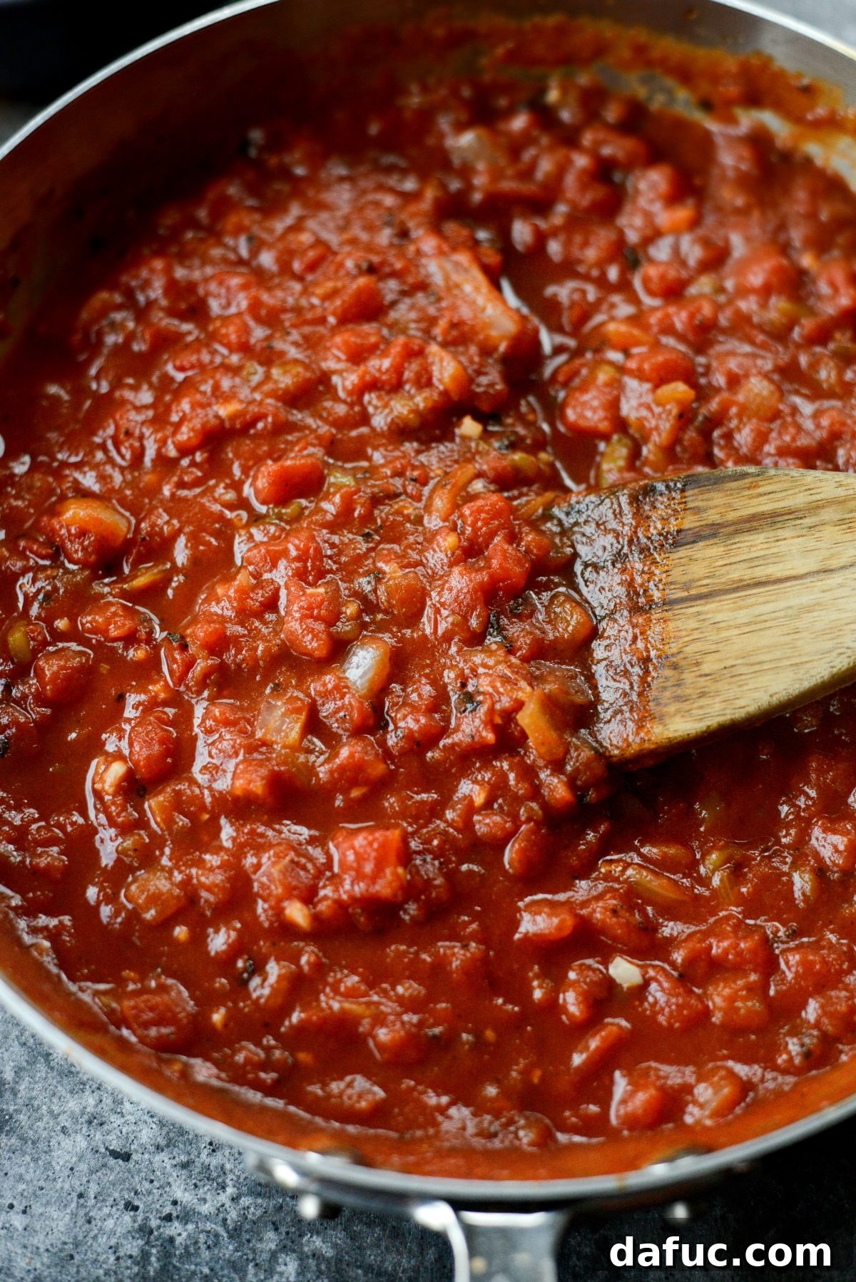 Hearty Chorizo and Sweet Potato Chilaquiles 9 Tomato sauce simmering and thickening in the skillet