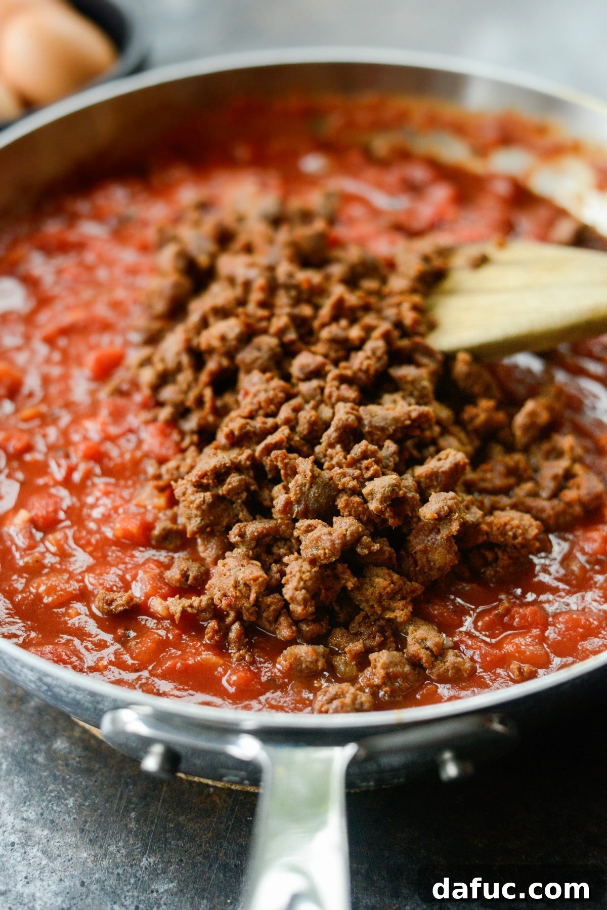 Hearty Chorizo and Sweet Potato Chilaquiles 10 Adding cooked chorizo back into the tomato sauce