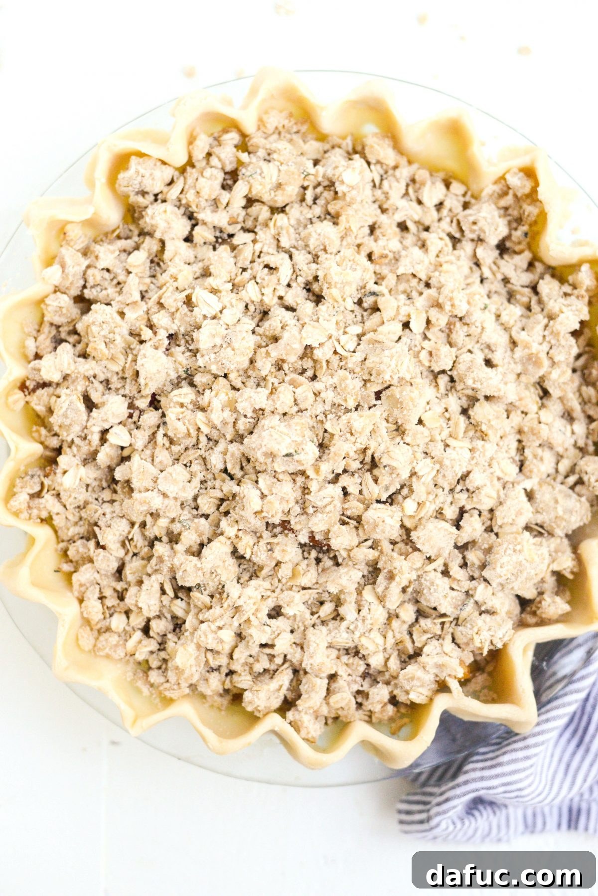 Unbaked Rustic Brown Sugar Apple Pie with Oatmeal Thyme Crumble, ready for the oven