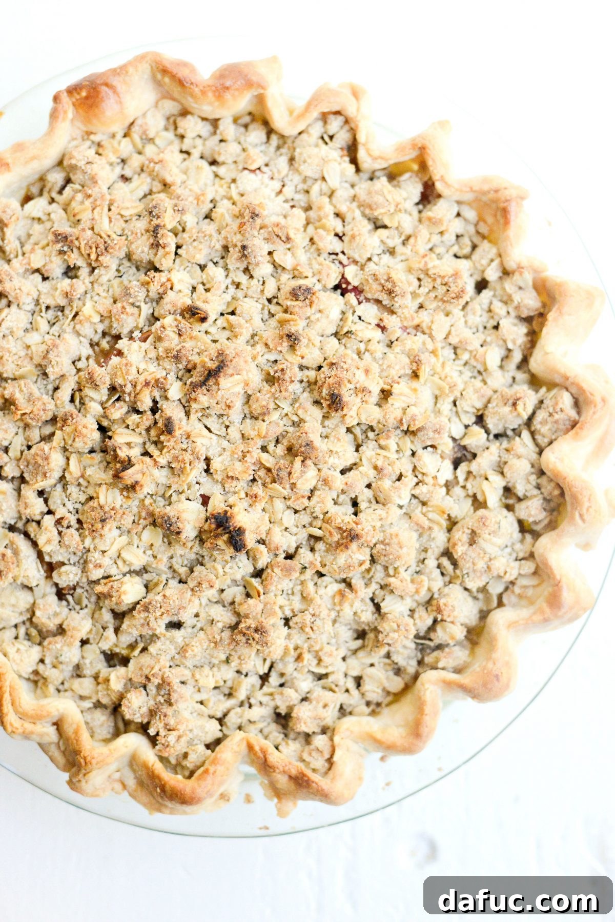 Freshly baked Rustic Brown Sugar Apple Pie with Oatmeal Thyme Crumble, golden and bubbling