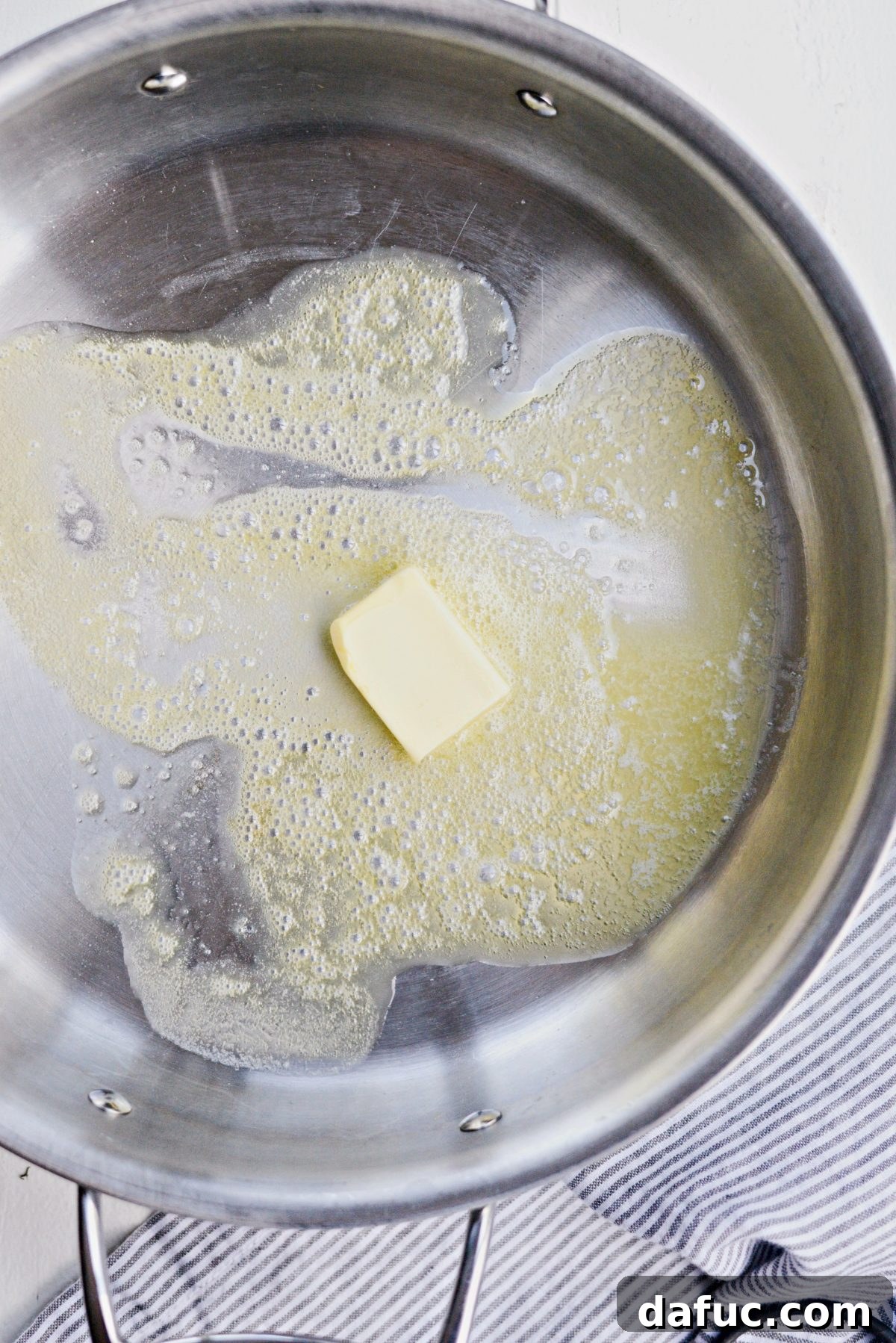 Melted butter shimmering in a large deep skillet