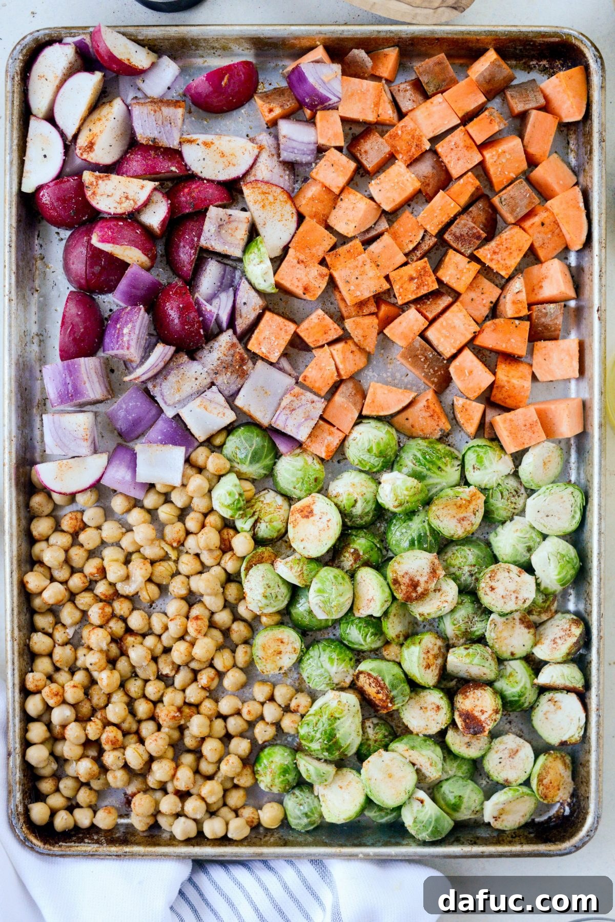 Make-Ahead Roasted Fall Veggie Rice Bowls 9 seasoned prepped veggies on a sheet pan