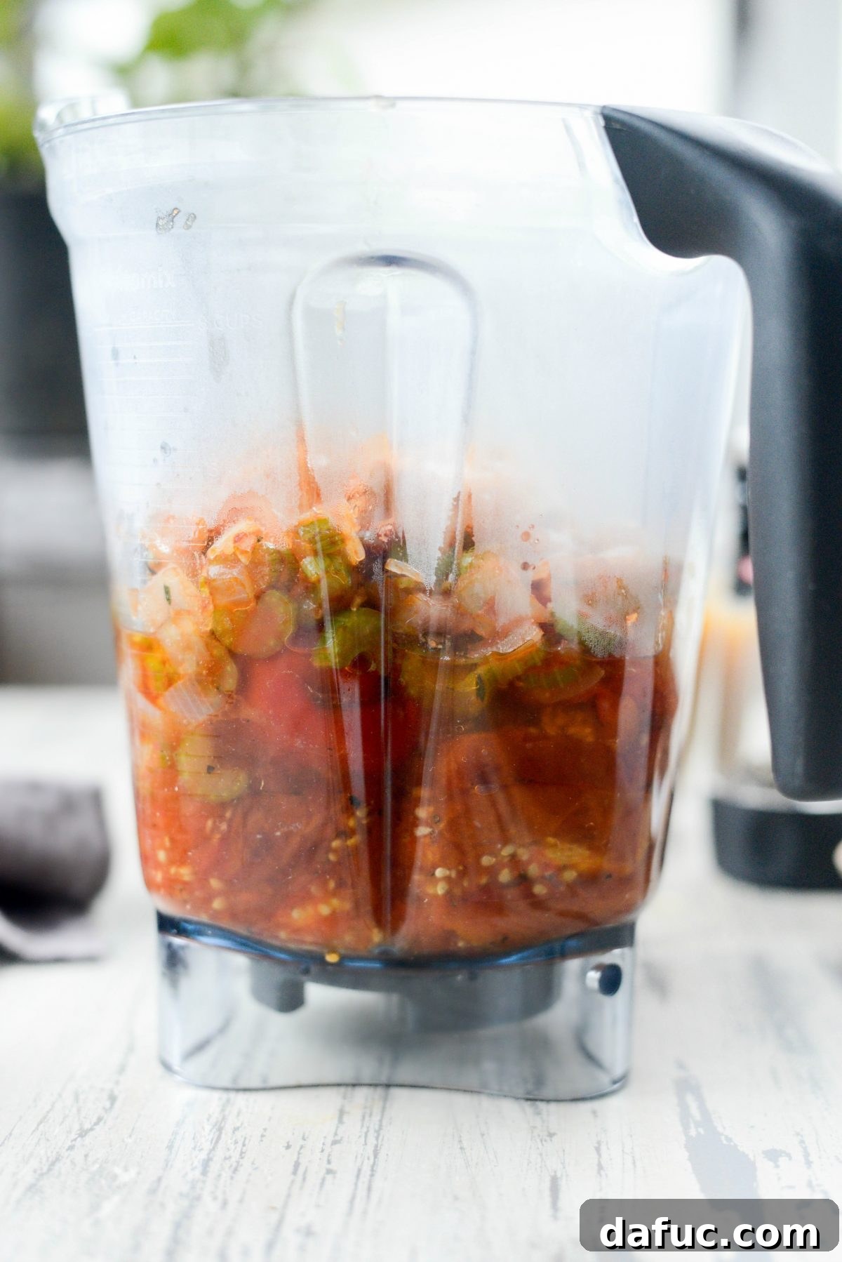 All roasted and sautéed vegetables, including tomatoes, red peppers, chipotles, onions, and celery, gathered in a blender.