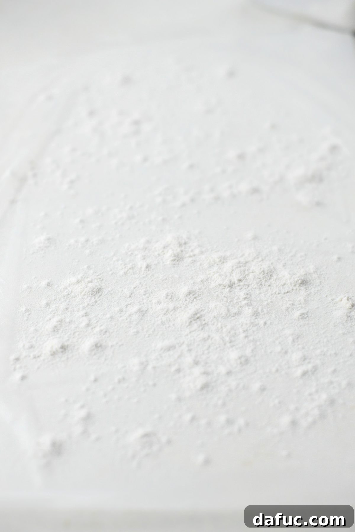 No-Knead Ciabatta: Easy Homemade Perfection 13 Flouring a large piece of plastic wrap on a countertop for handling ciabatta dough
