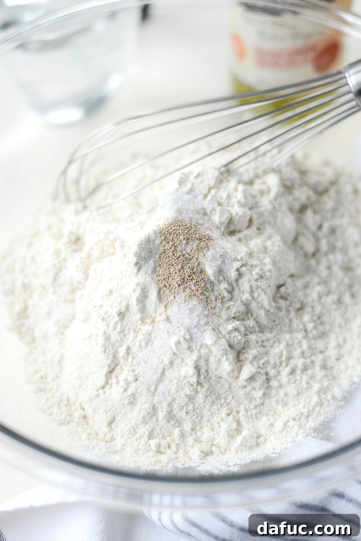 No-Knead Ciabatta: Easy Homemade Perfection 5 Three bowls containing unbleached all-purpose flour, kosher salt, and active dry yeast